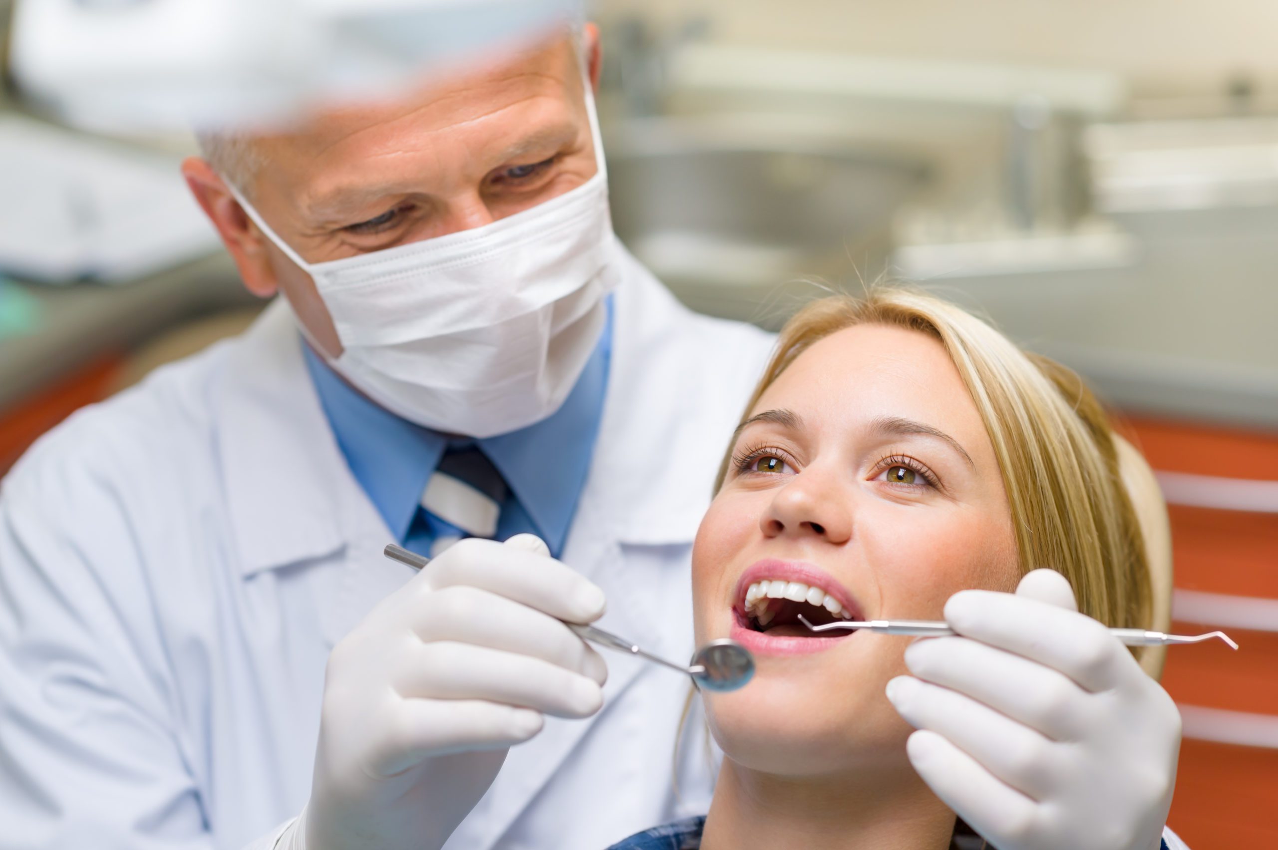 Healthy teeth patient at dentist office dental caries prevention - Orthodontic services during a health crisis