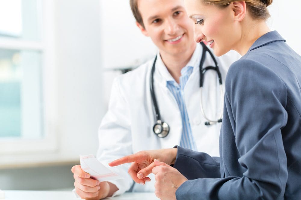 Doctor with patient in clinic consulting