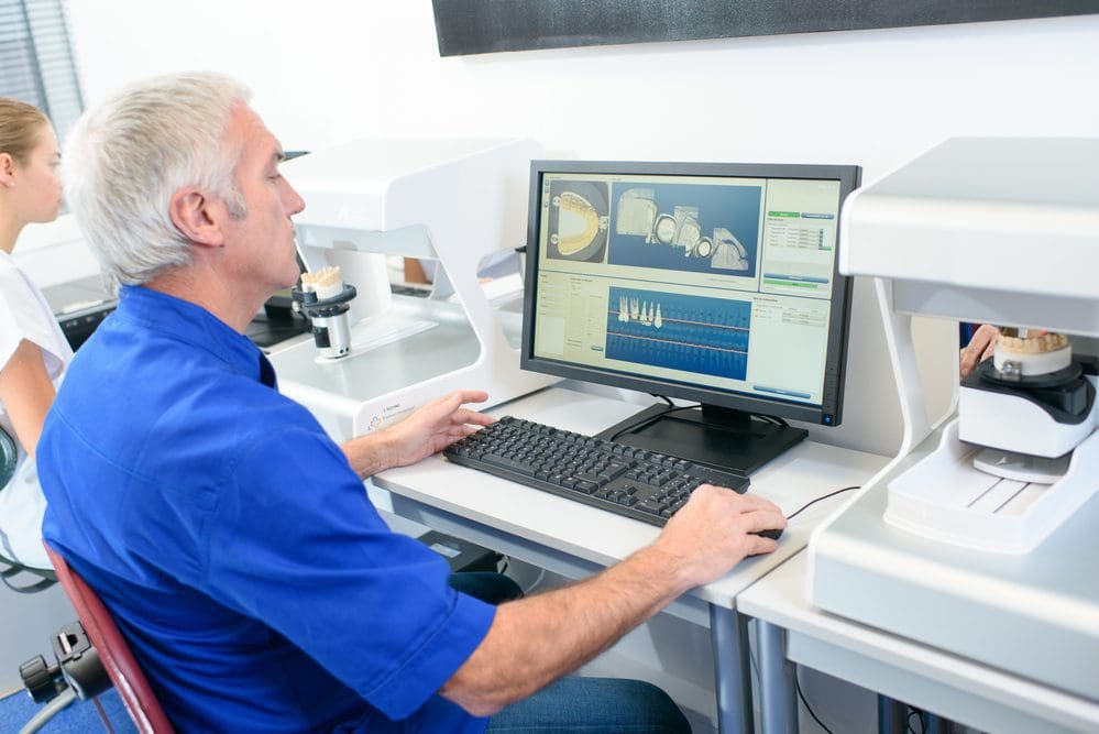 Senior dentist sat at his desk