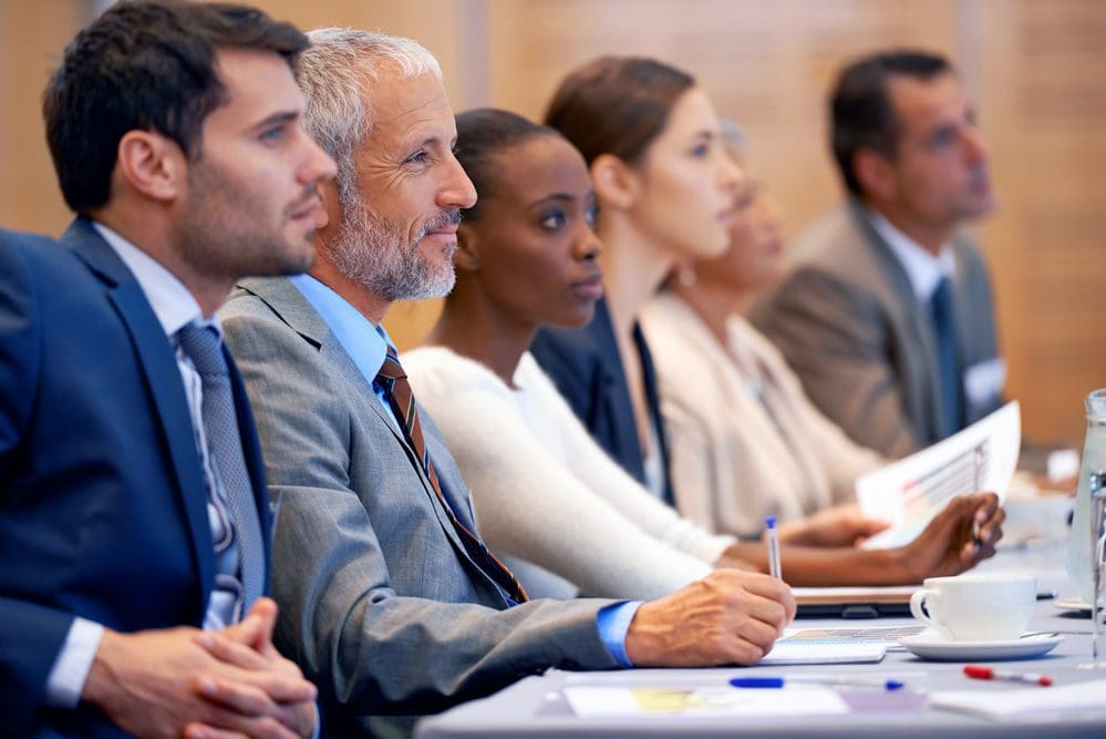 Shot of a group of people sitting in a conference.