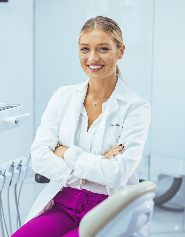 female doctor smiling with arms crossed