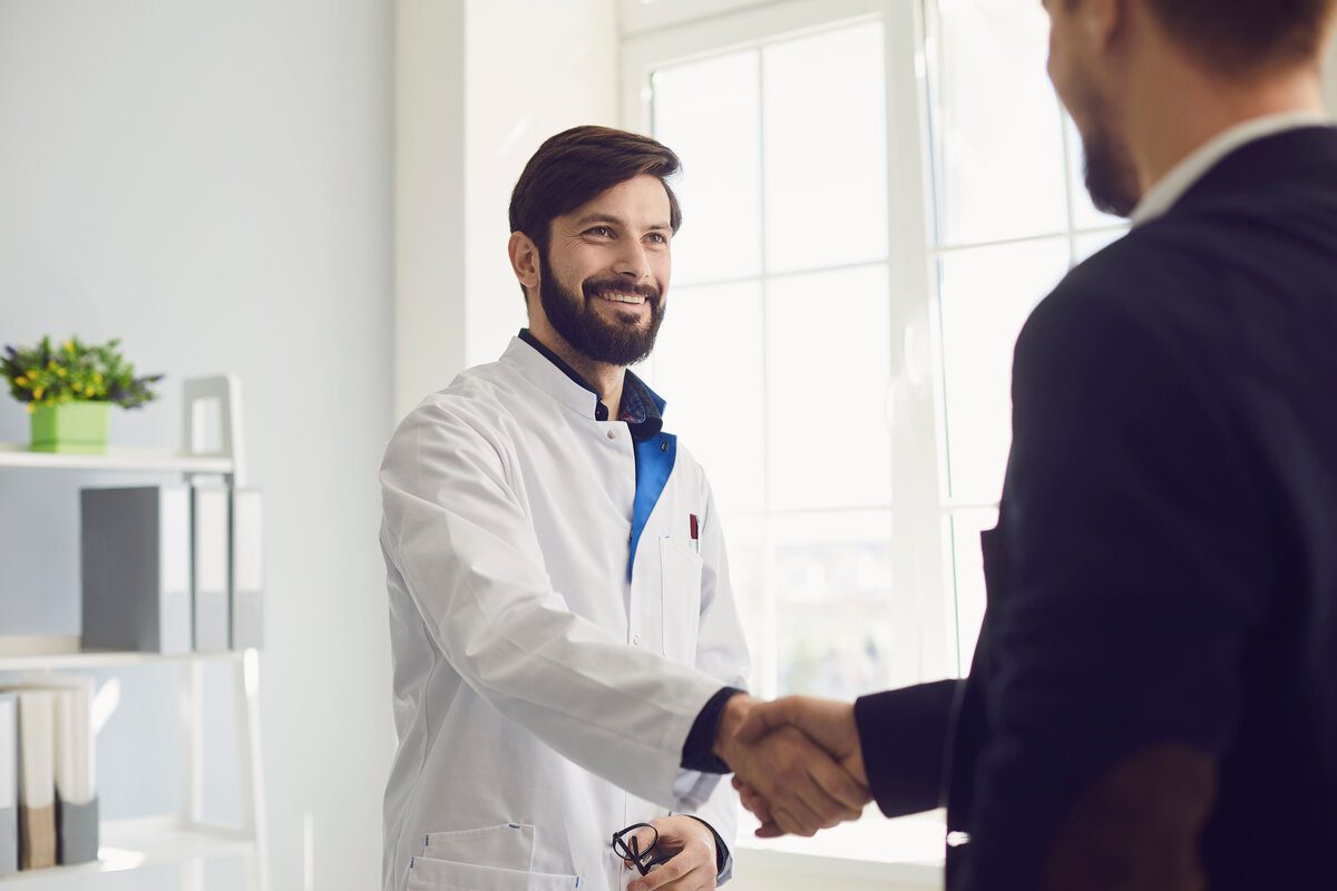 doctor shaking hands with patient